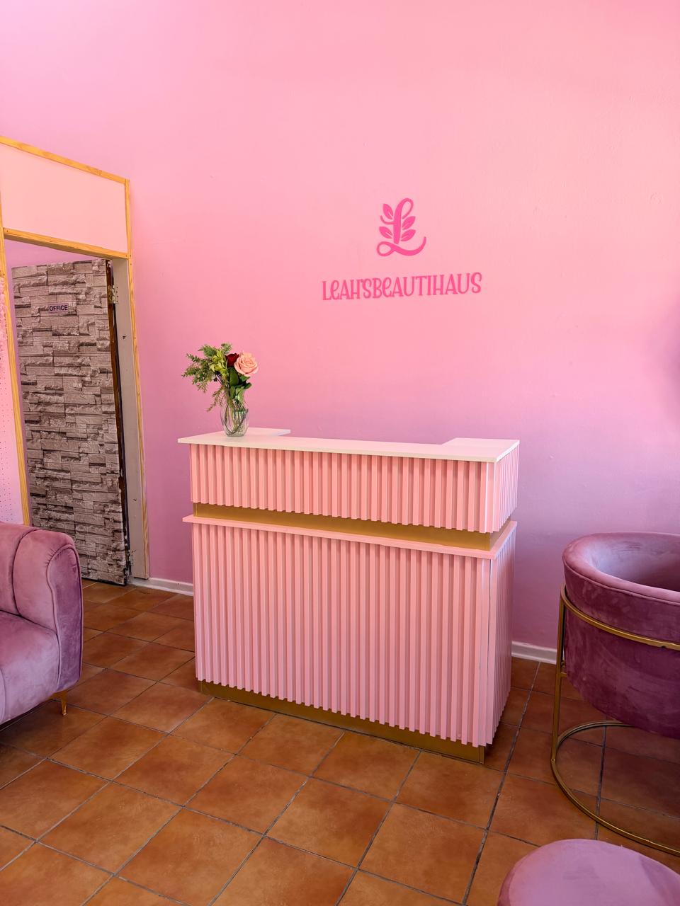 Leah's Beautihaus salon reception area in soft pink tones